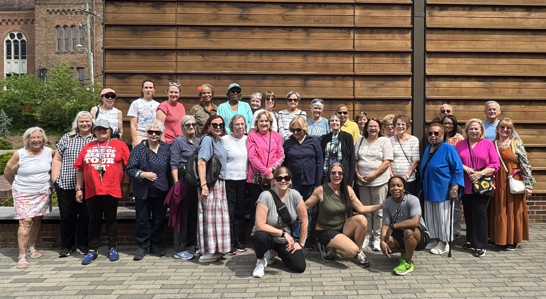 An outdoor group photo of people on a YMCA of Greensboro Active Older Adults trip.