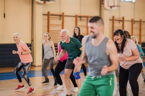 A smiling and happy group of people dancing.