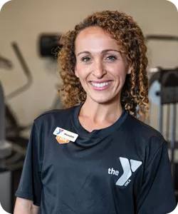 Meredith Knowlton Dennis poses for a photo at the Reidsville YMCA. She is smiling at the camera.