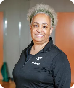 A portrait of Leslie Justice, personal trainer at the Bryan YMCA. She is smiling at the camera.