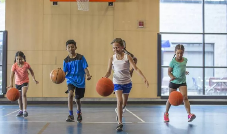 kids dribbling basketballs