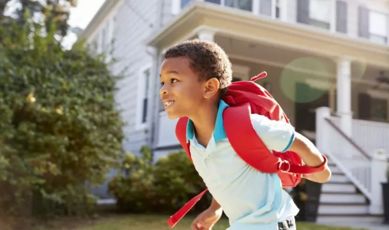 Child running with backpack