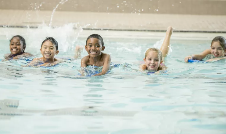 Children swimming together in a pool.