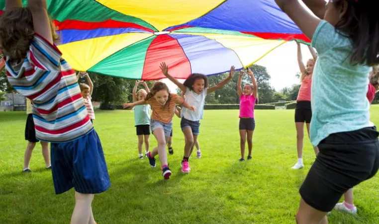 kids playing under big tent