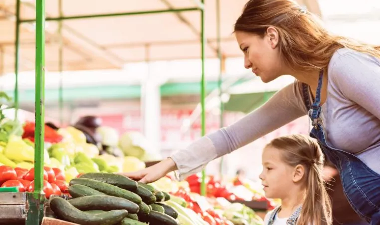 woman and child selecting produce at market