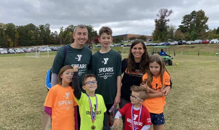 Josh Dettinger, a Y volunteer, and his family. 