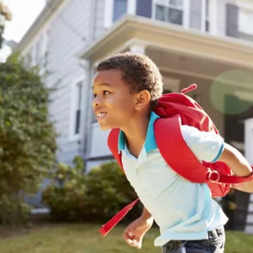 Child running with backpack