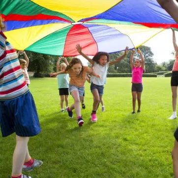 kids playing under big tent