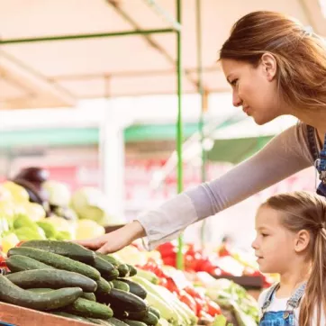 woman and child selecting produce at market