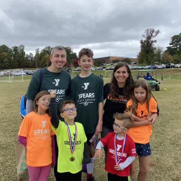 Josh Dettinger, a Y volunteer, and his family. 