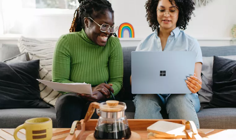Two females looking at a computer.
