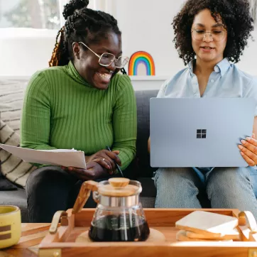 Two females looking at a computer. 