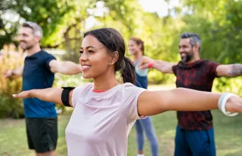A group of people in an outdoor fitness class.