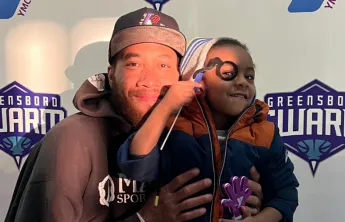 Man and child smiling at Y Night - Greensboro Swarm