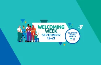 A background made of blues and greens with a white YMCA logo and 3 small yellow triangles among blue and green triangles. An illustration of a diverse group of people stands at the left side of the image. The center of the image reads "Welcoming Week" in medium and dark green, and "September 12-21" in dark blue. On the right side of the image, a white circle with a dark blue border holds the words "Belonging Begins with Us" in dark blue text.