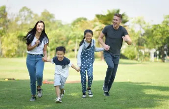 Asian family having fun outside
