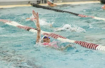 young swimmer competing on swim team