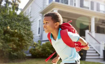 Child running with backpack