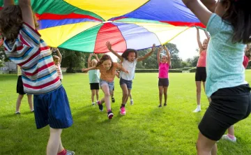 kids playing under big tent