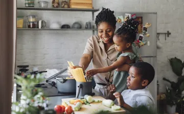 A family cooking together in the kitchen.