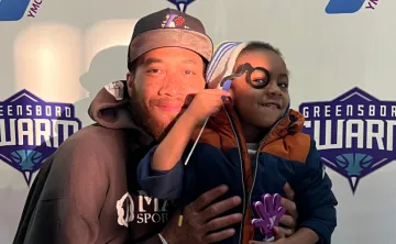 Man and child smiling at Y Night - Greensboro Swarm