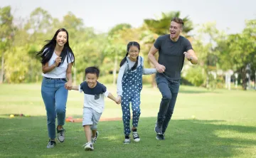 Asian family having fun outside