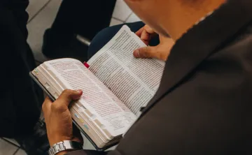Overhead view of guy reading bible