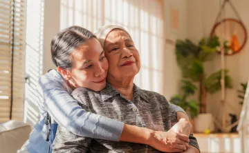 A caregiver embracing their loved one