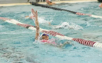 young swimmer competing on swim team