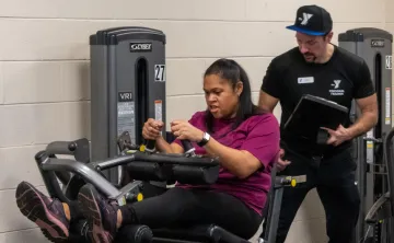 Personal trainer assisting their trainee 