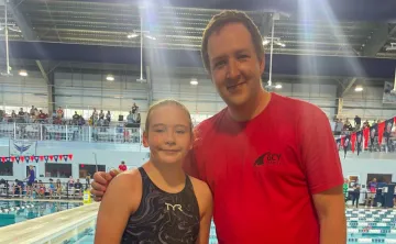 GCY Swim member and coach posing for a photo
